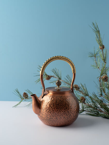 Take your tea to the next level with our stunning, Handmade Copper Kettle. Copper is among the top choices for teaware as it offers optimal heat conduction ability. It allows you to boil the water within at a rapid pace while retaining the heat afterward. Copper is known to resist staining and prevent the buildup of potential bacteria that could grow in your teapot. Our deluxe hammered copper kettle also features a hinged handle coiled in brass for a sure grip, and a floral detailed pull knob on the lid. Copper inside and out.