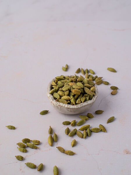 A Caring Guide To Cardamom Whole green cardamom are small seed capsules with papery outer shells. They have ridges running along their length and taper at either ends. When fresh, and quality-dried, they are green in color and somewhat plump. The capsules are triangular in cross-section, and when opened reveal 15-20 small black-brown and intensely aromatic seeds.